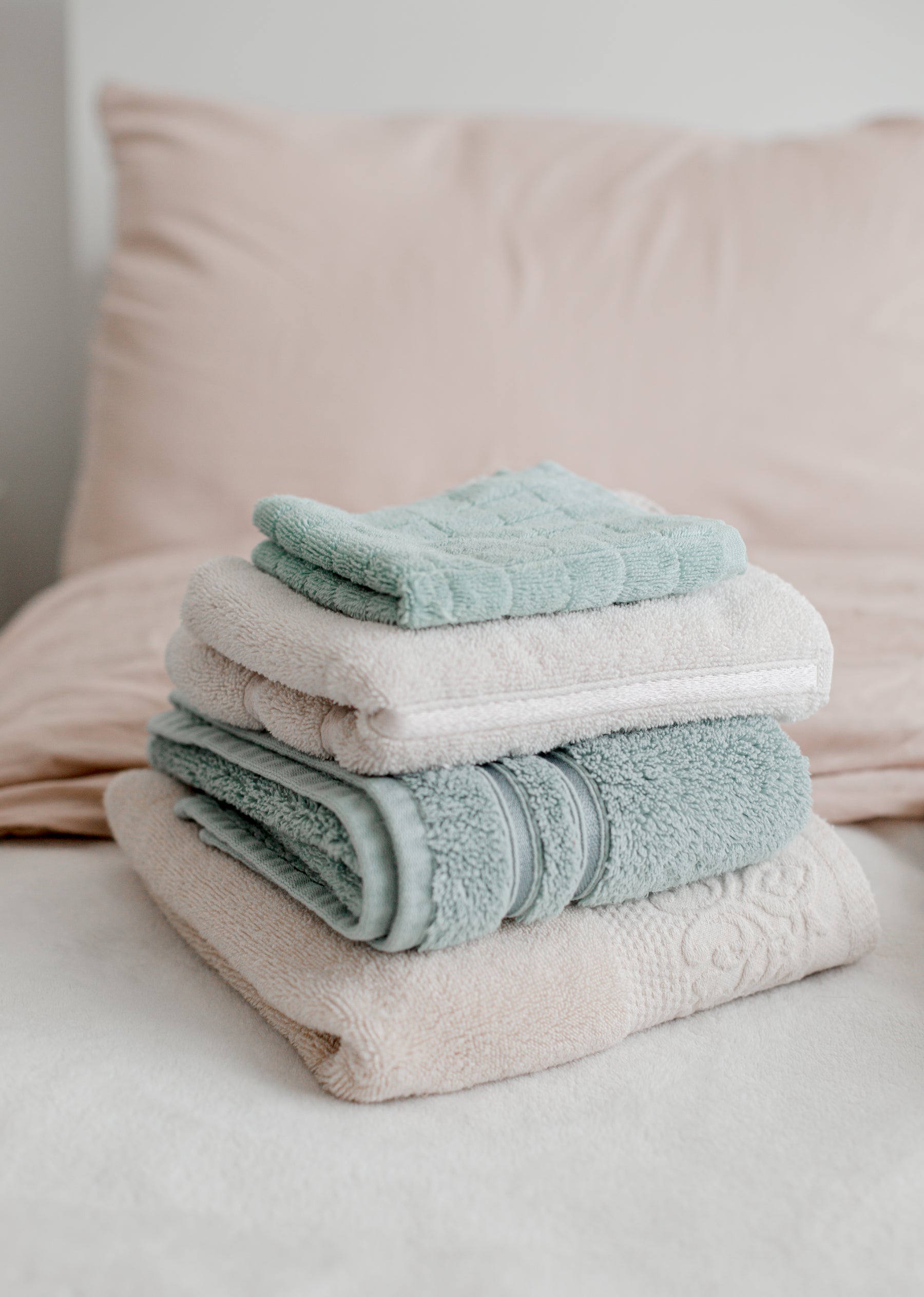Folded dusty blue and pink towels